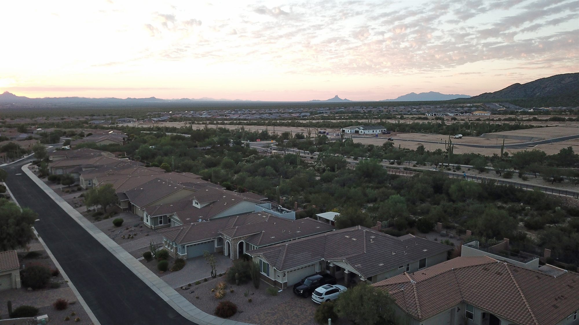 Drone view of a Tucson-area residential community with mountains behind