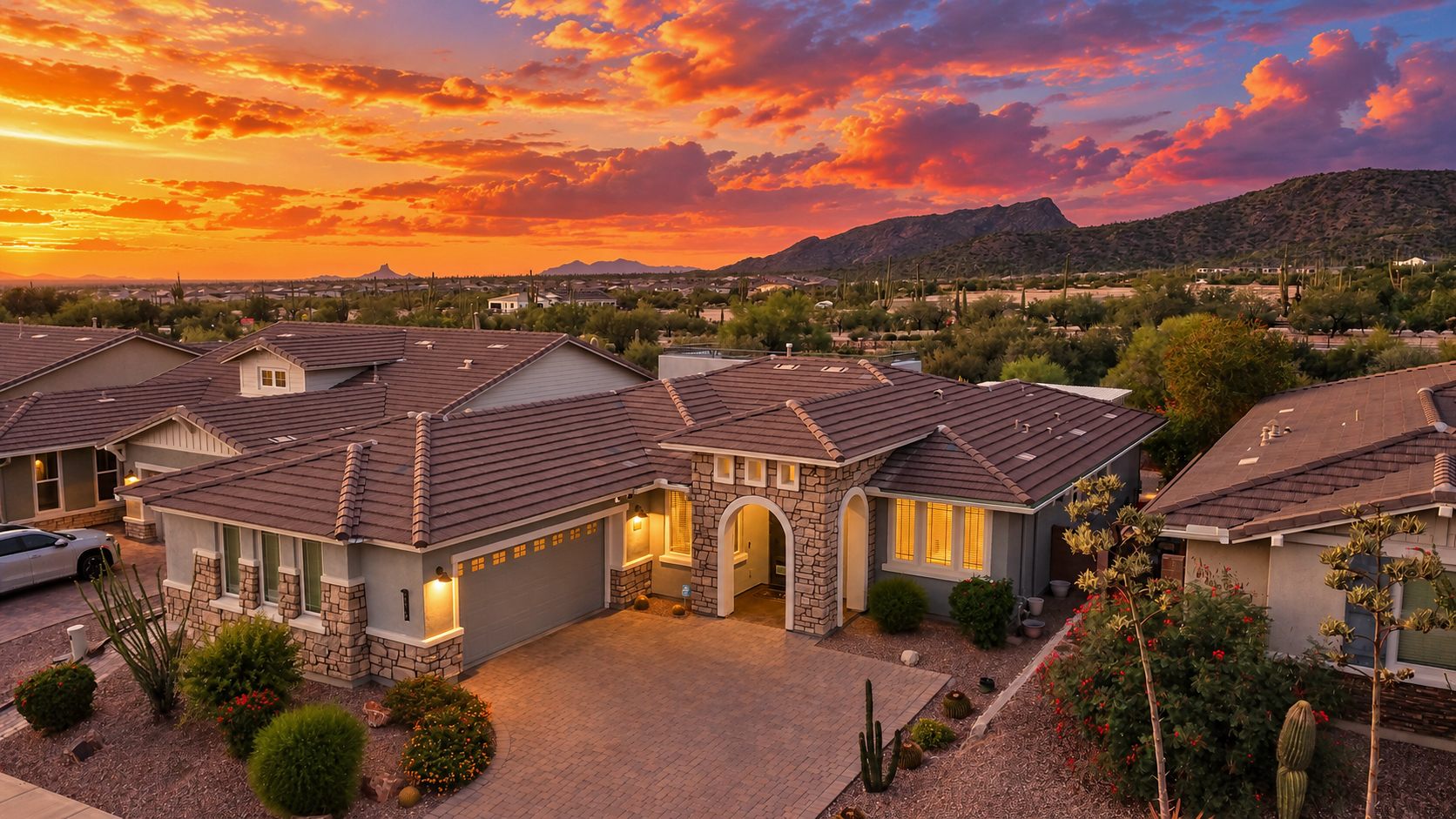 Aerial view of a Tucson-area home at sunset with mountains behind