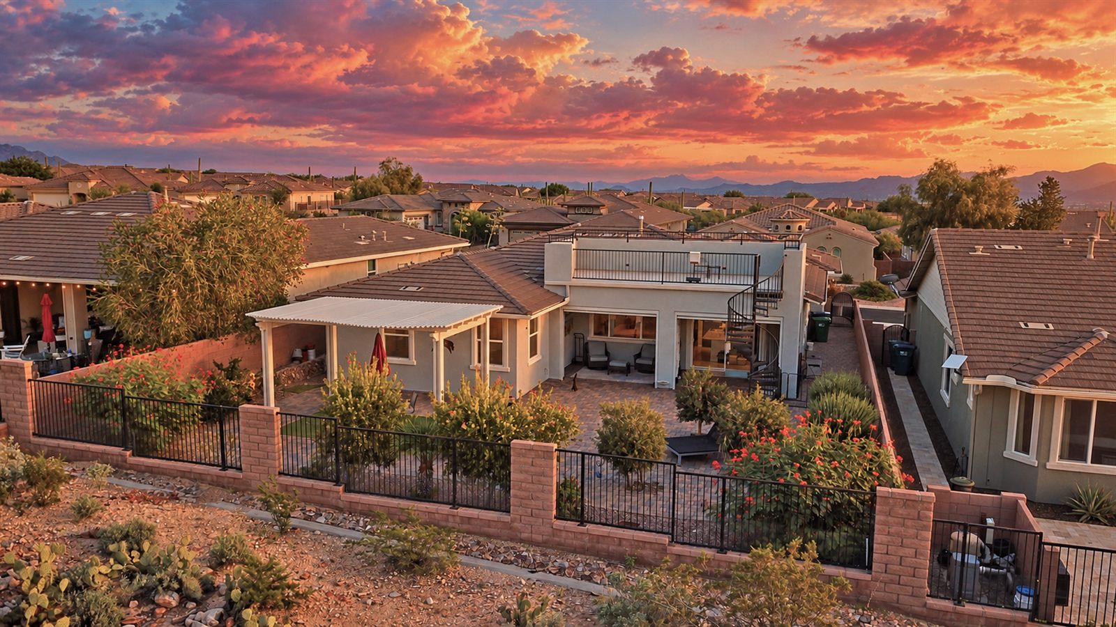 Drone view of a home's backyard and patio at sunset